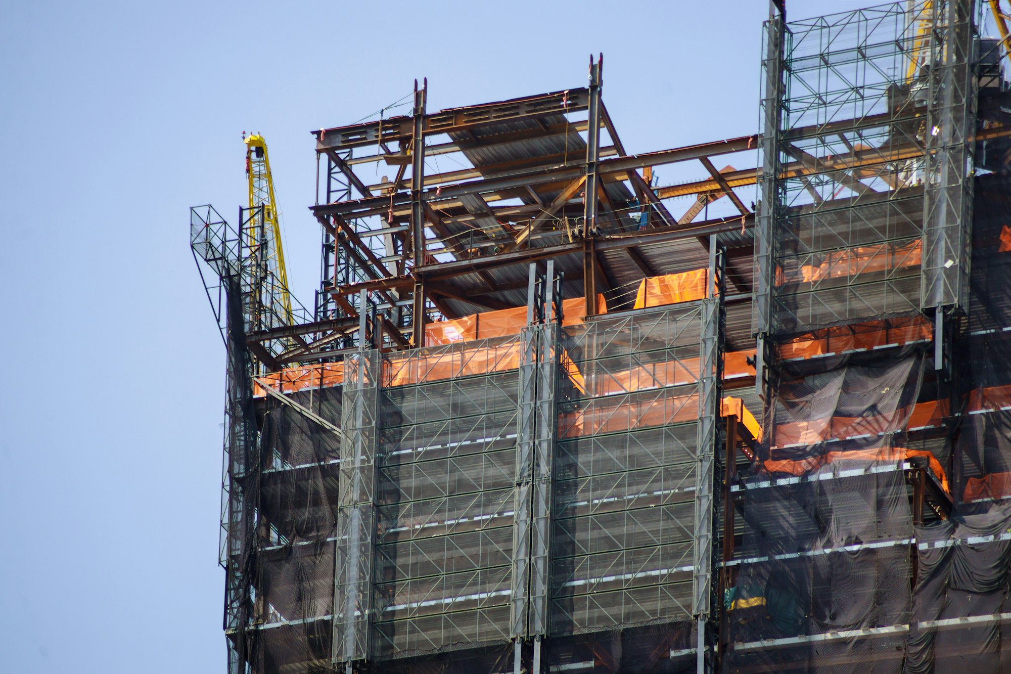 Construction site with crane and multi level commercial high rise building